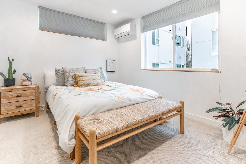 The third-floor bedroom offers another Casper queen bed, warm tones, and soft textures