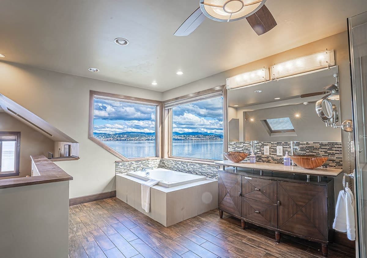 The master bath stands as a sanctuary, featuring a corner jacuzzi that offers serene views of Lake Washington