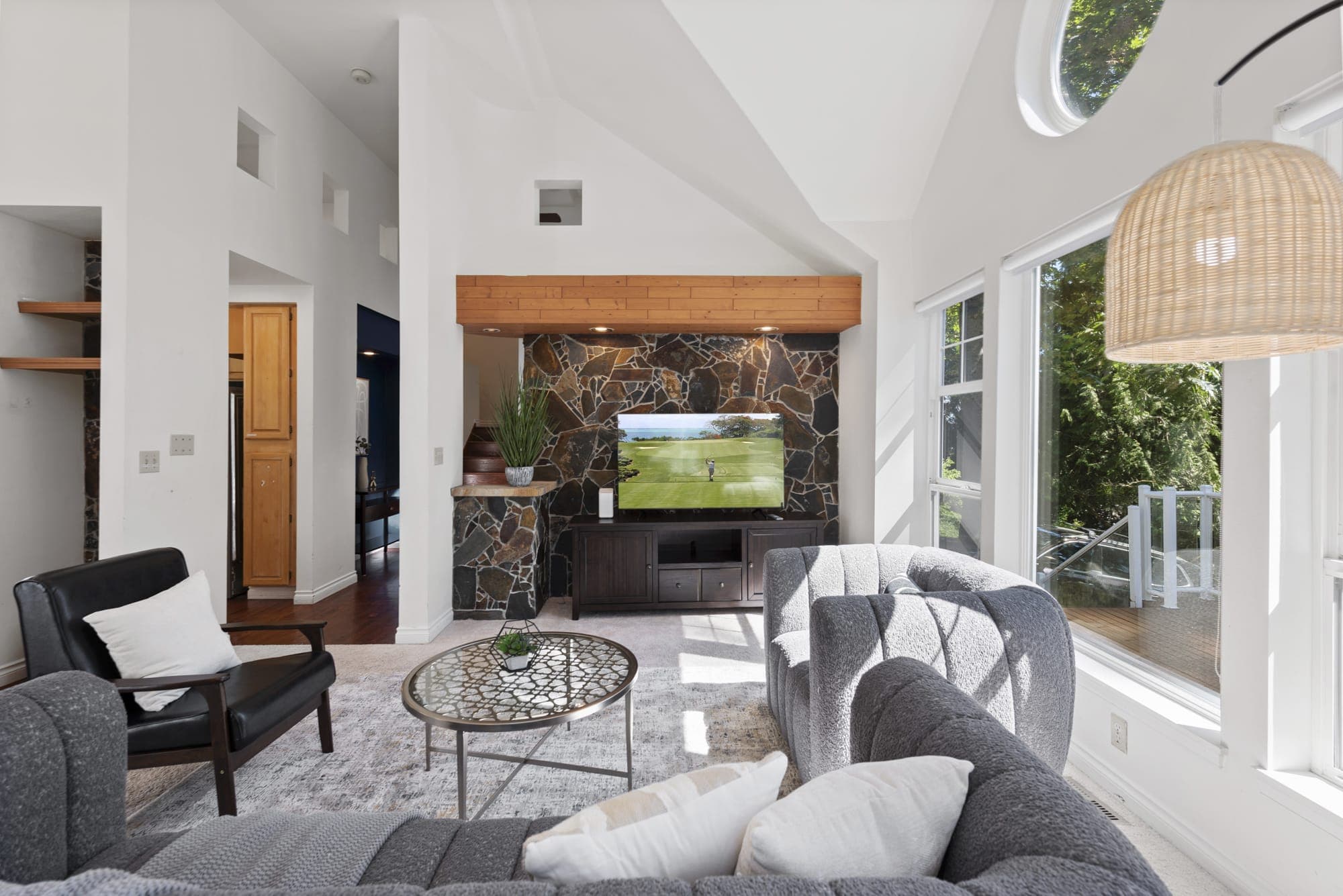 Relax and unwind in this well-lit living room, with panoramic windows to enjoy the view outside.