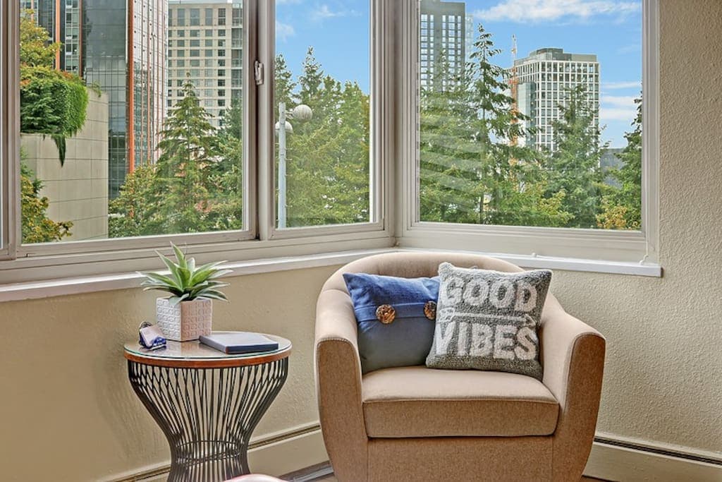 Cozy reading nook with city views, perfect for morning coffee or winding down with a book. Filled with light and good vibes.