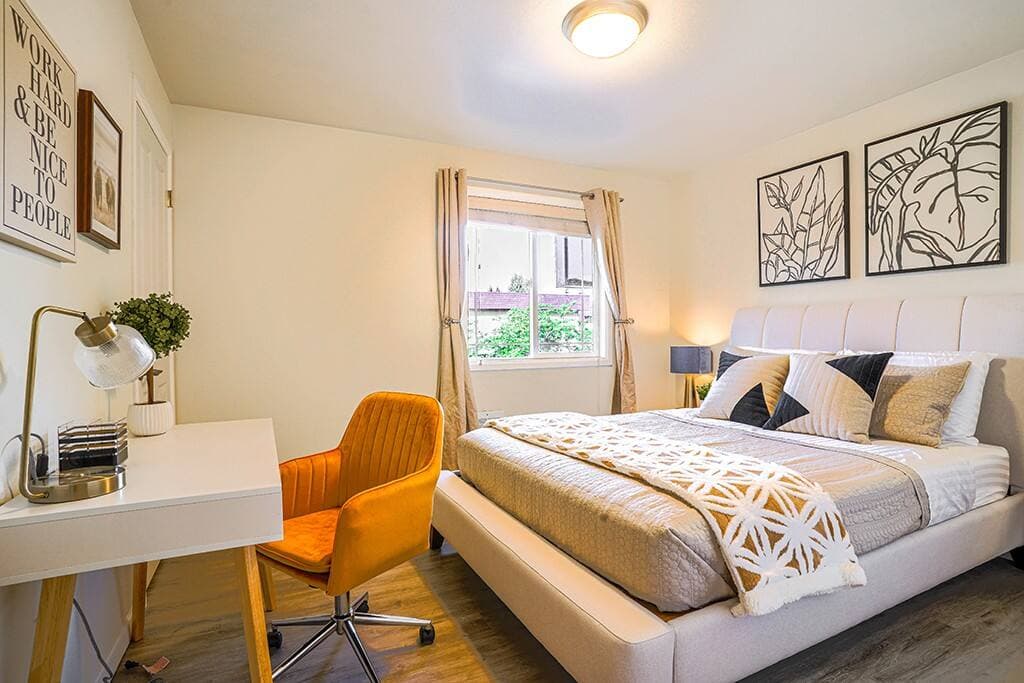 Upstairs bedroom is tastefully designed and equipped with a comfortable queen bed and a dedicated working station