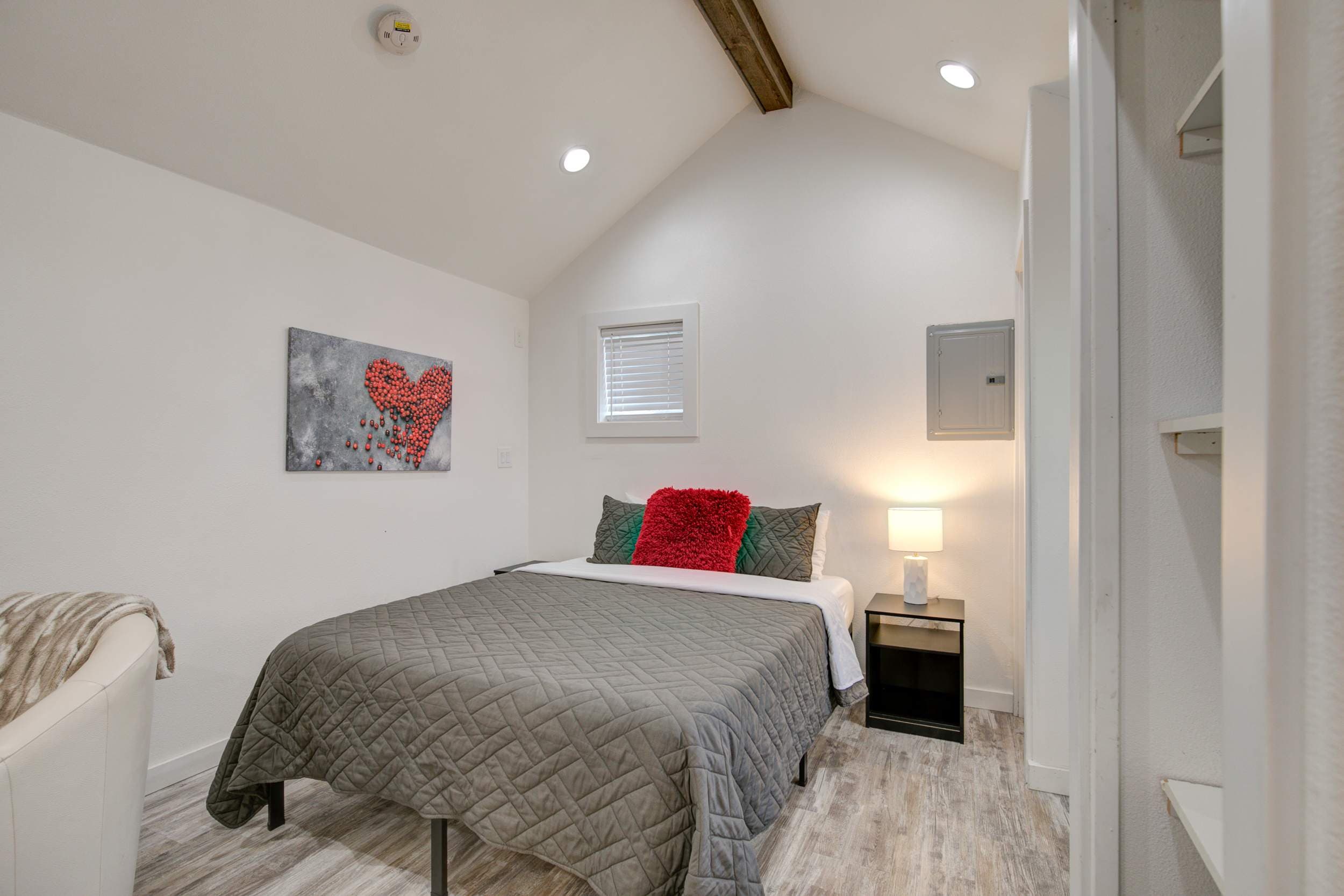 Elegant bed surrounded by fresh, white interior – a serene and peaceful retreat.