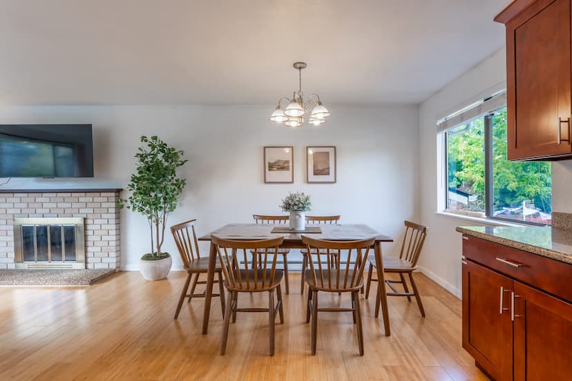 An inviting open-concept dining area flowing into a well-appointed kitchen, perfect for entertaining.