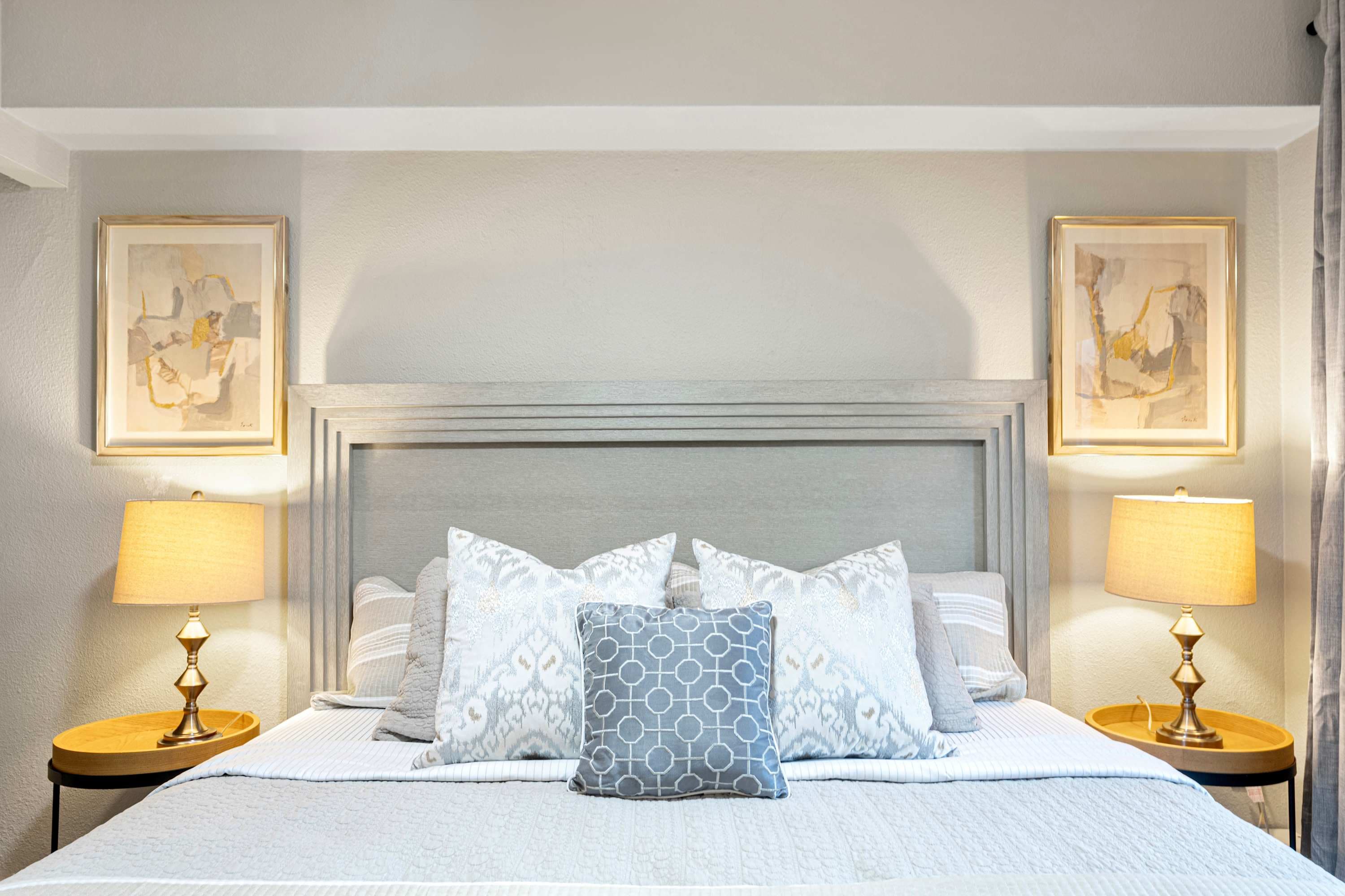 Relax in the luxurious bedroom featuring a comfortable king-size bed and warm lighting.