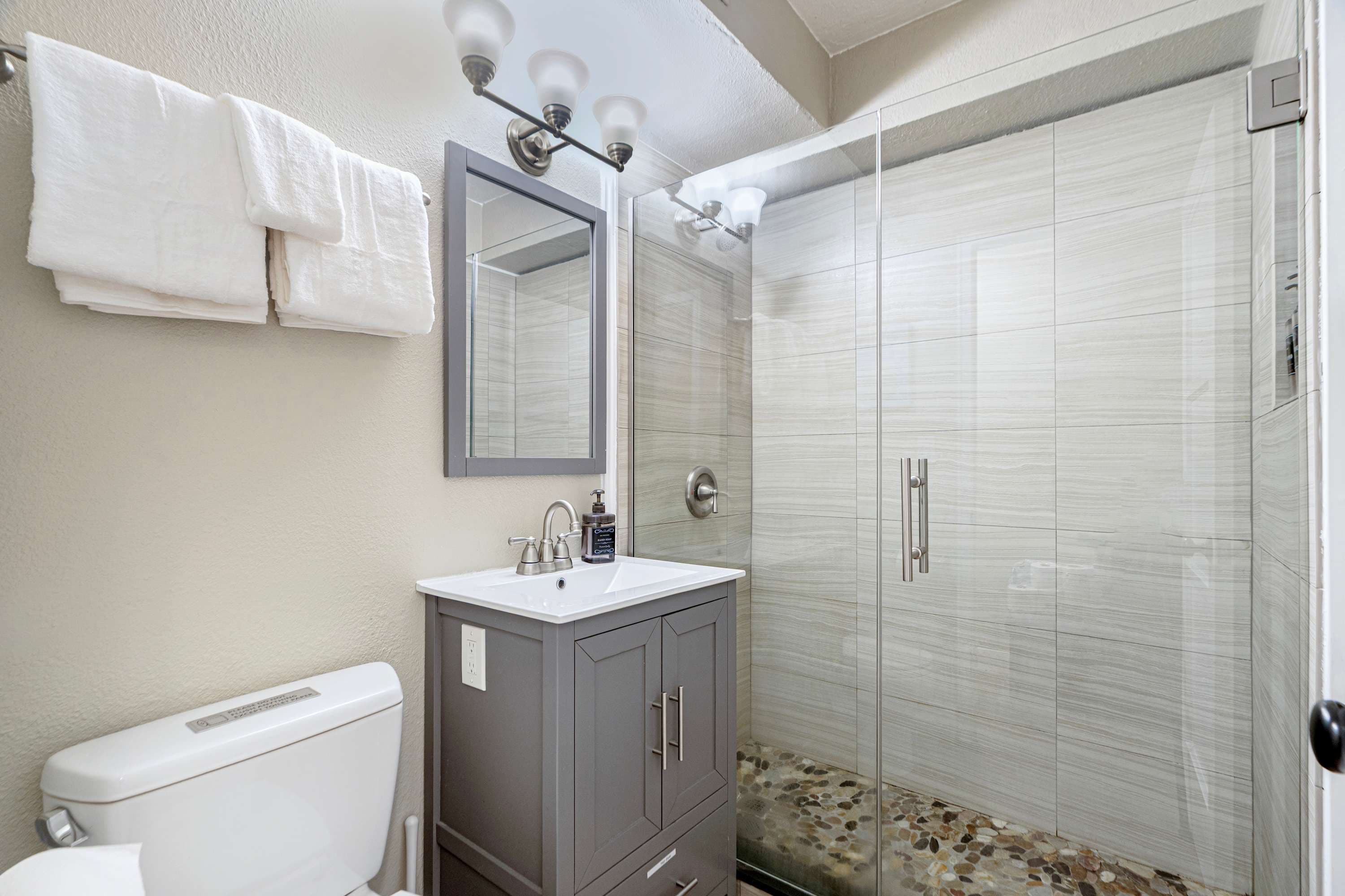 Feel refreshed with a rejuvenating shower in the sleek bathroom with contemporary fixtures.