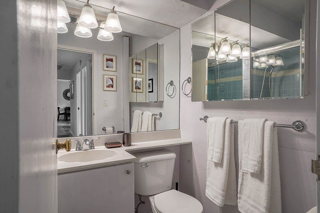 Unwind in the clean and contemporary bathroom, offering sleek fixtures, a spacious vanity, and a soothing atmosphere perfect for refreshing after a long day.