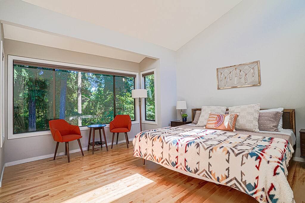 Master bedroom with large windows and seating