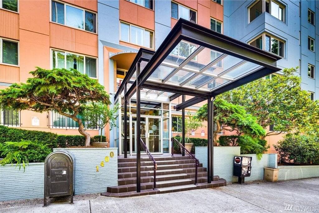 Welcome to this vibrant and modern condo building featuring a sleek glass canopy entrance, lush greenery, and a secure, stylish entryway at 1400.
