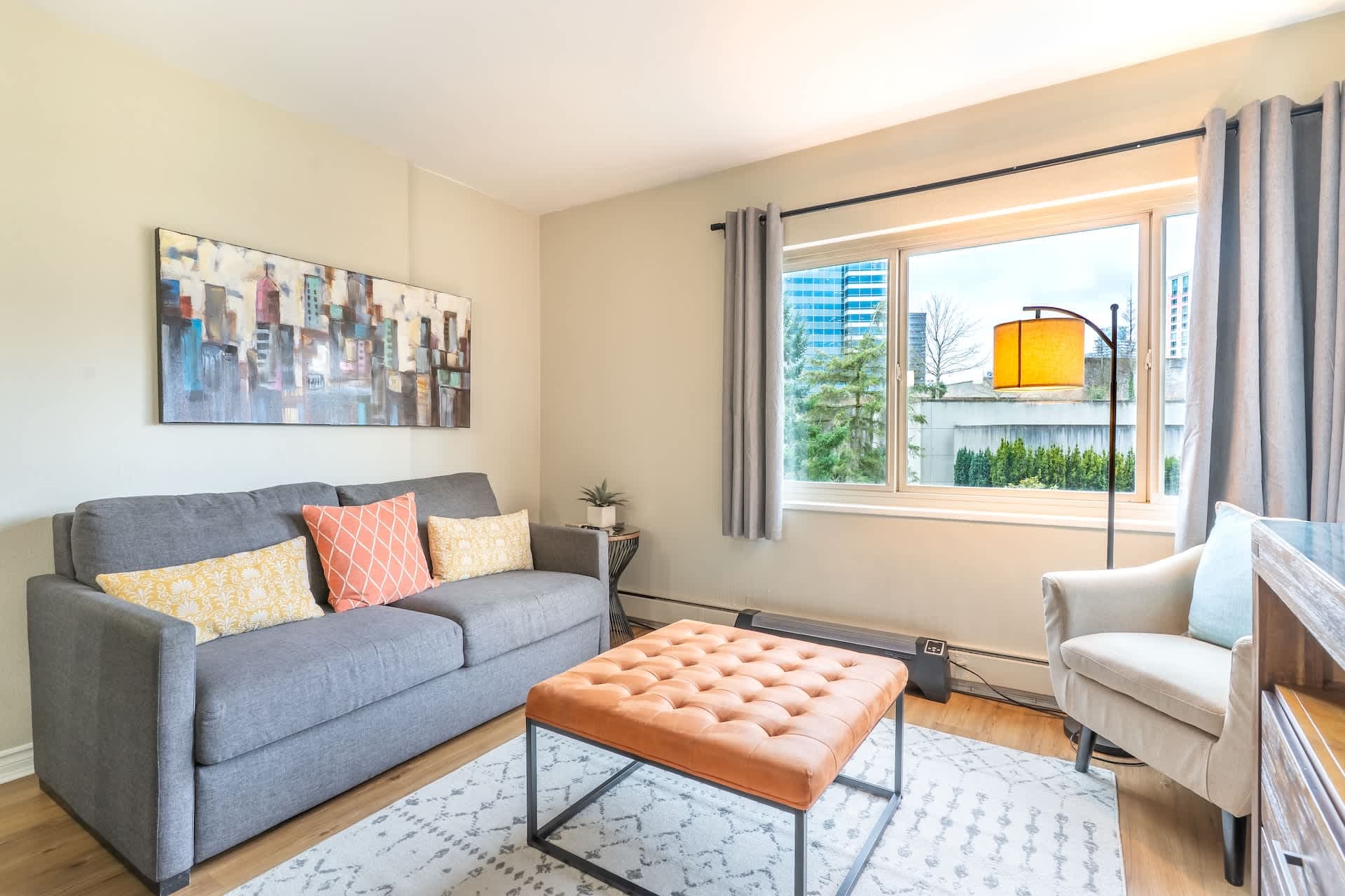 This inviting living room boasts stylish leather furniture, a spacious coffee table, and a flat-screen TV for relaxation.