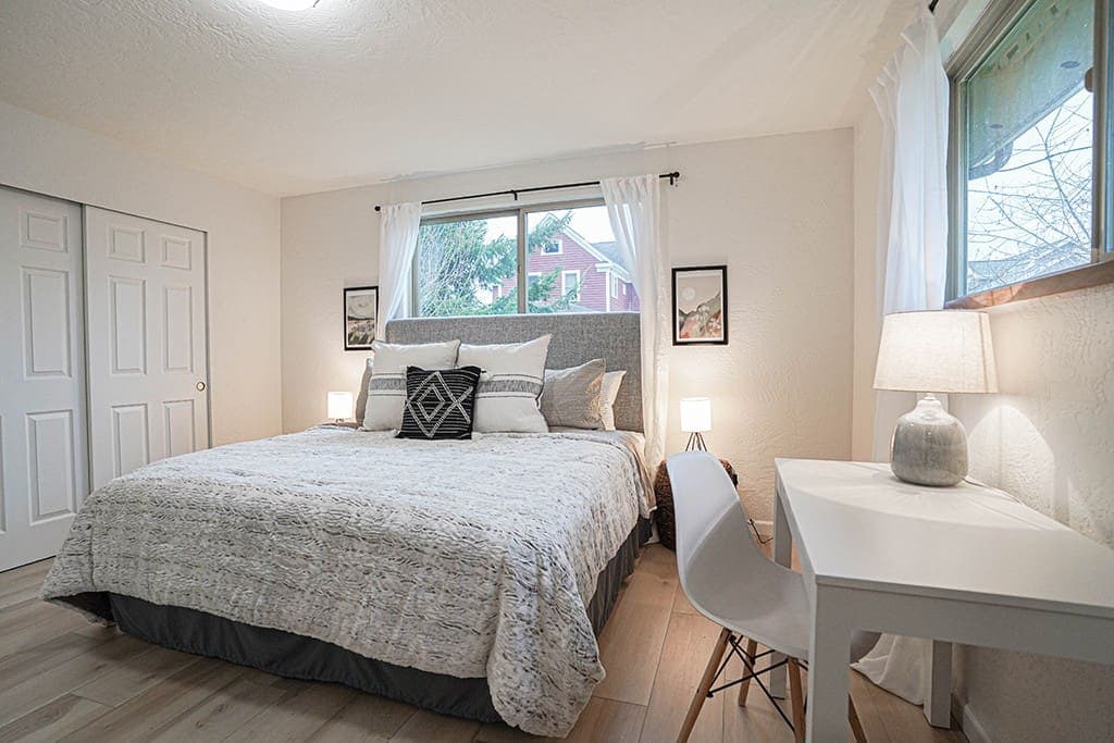 The master bedroom includes a king-sized bed, TV and working desk