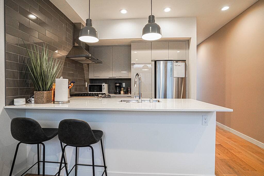 The cabinets are stocked with all necessary cookware and utensils, making it easy to prepare meals.