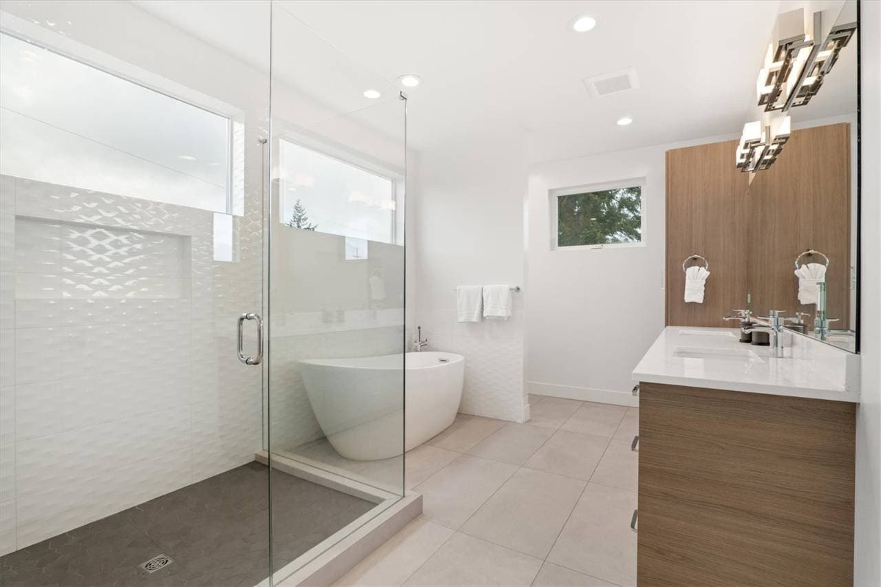 Relax and rejuvenate in this spa-like bathroom featuring a luxurious soaking tub, sleek walk-in shower, and modern finishes designed for ultimate comfort.