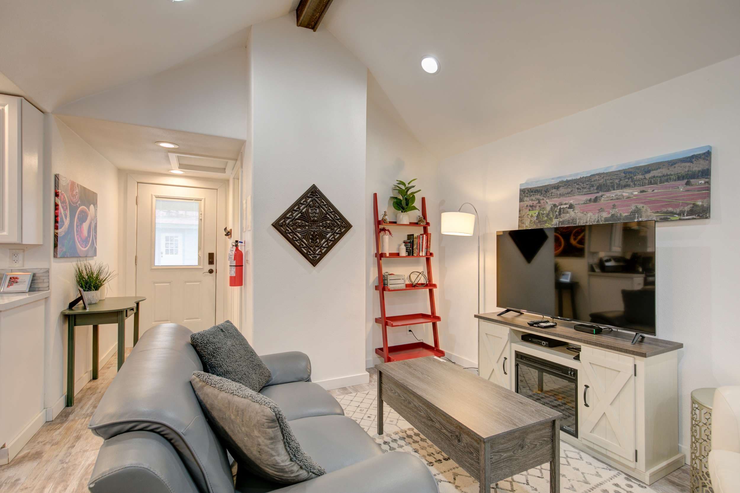 Relaxing living room featuring a comfortable sofa and TV for your entertainment.