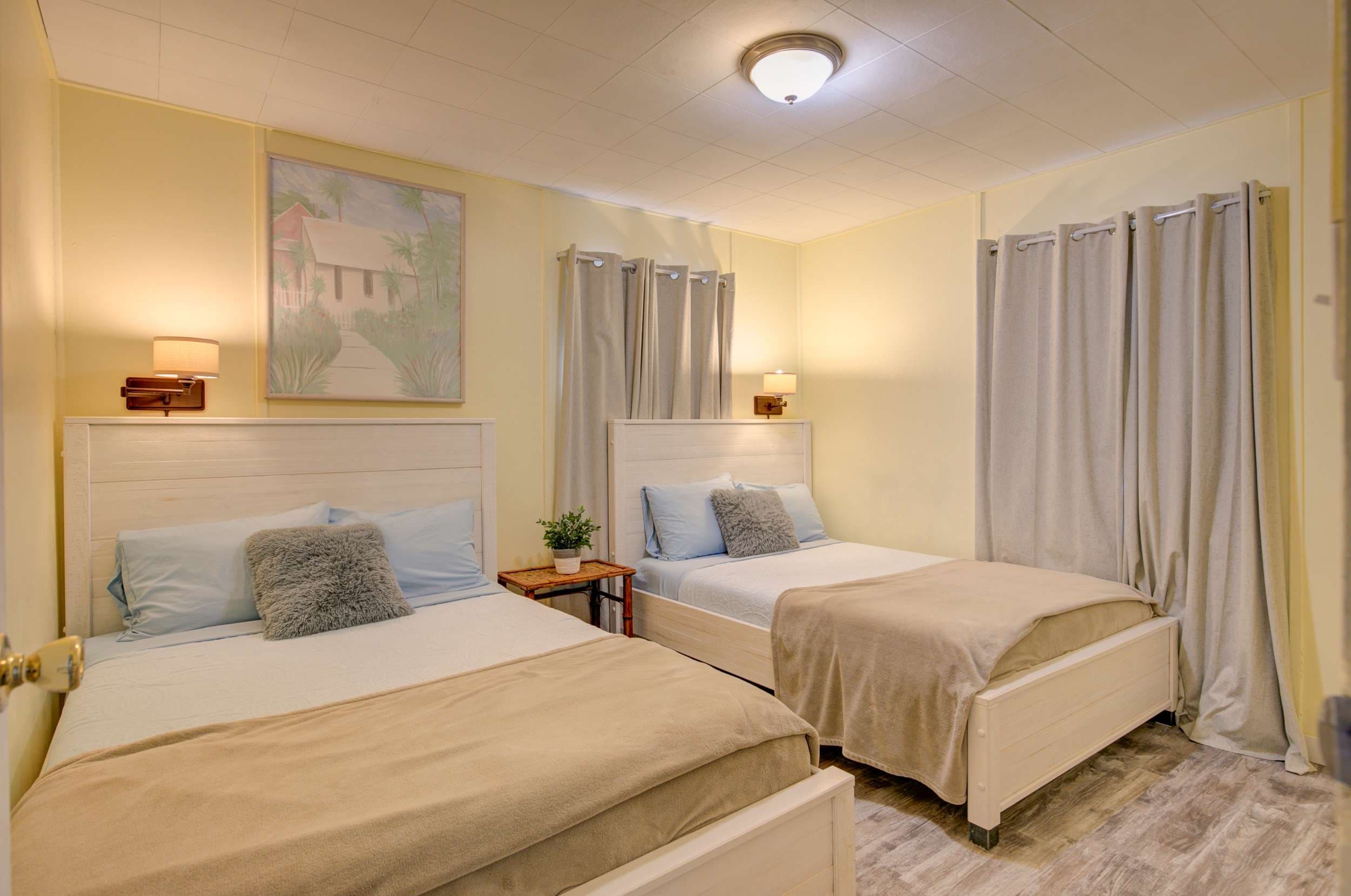 Bedroom 1 with two double beds, ideal for a comfortable stay.