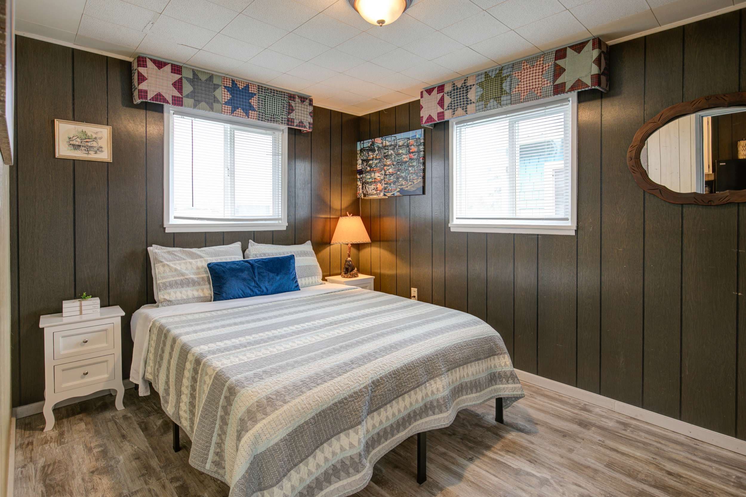 Queen bed with dark wood interior, creating a restful and elegant atmosphere.