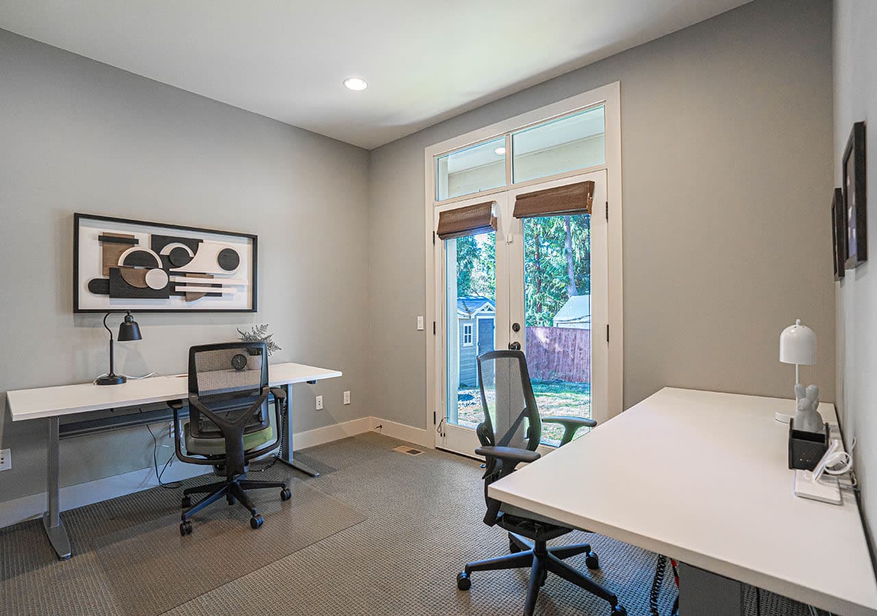 The built-in desk area offers a convenient and functional workspace with matching cabinetry, ideal for working from home, managing household tasks, or homework in a quiet corner of the open-concept layout.