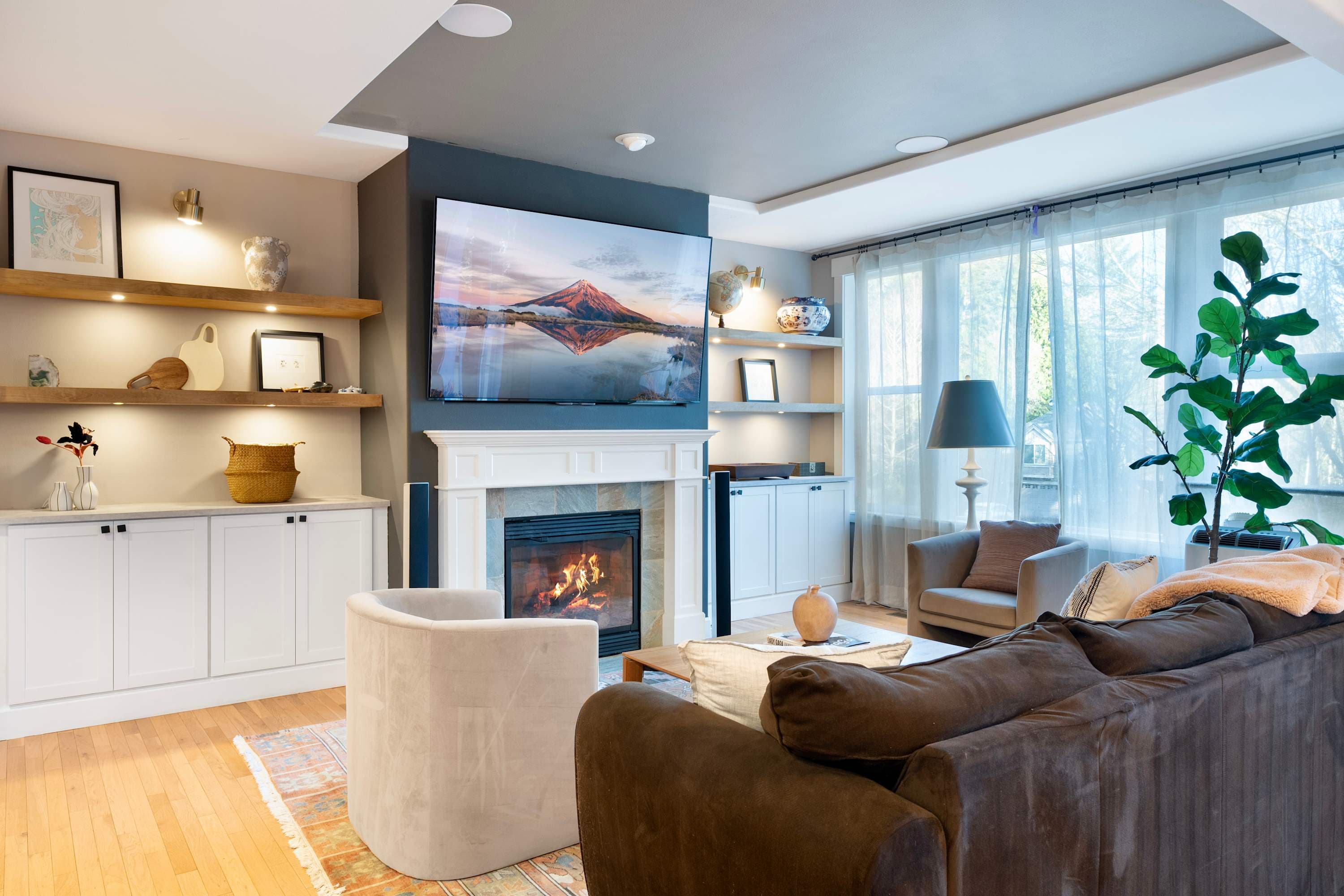 Step into a living area where comfort meets style, featuring a cozy fireplace and TV that set the perfect ambiance